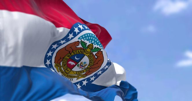 The US state flag of Missouri waving in the wind. Missouri is a state in the Midwestern region of the United States. Democracy and independence.