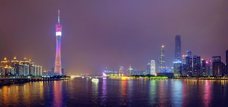 Guangzhou cityscape skyline ver the Pearl River illuminated in the evening panorama. Guangzhou, China.