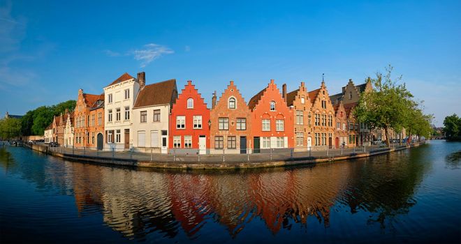 Typical Belgian cityscape Europe tourism concept - panorama of canal and old houses on sunset. Bruges (Brugge), Belgium