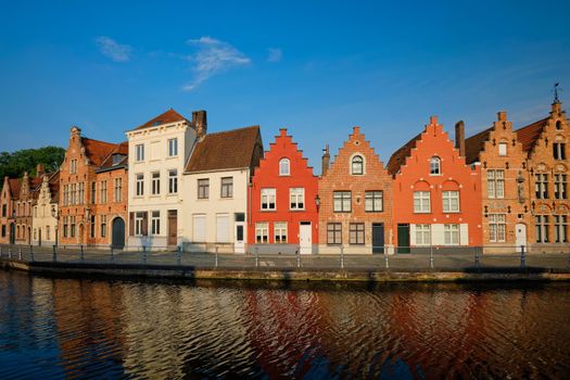 Typical Belgian cityscape Europe tourism concept - canal and old houses on sunset. Bruges (Brugge), Belgium