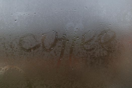 word coffee on a foggy window.
