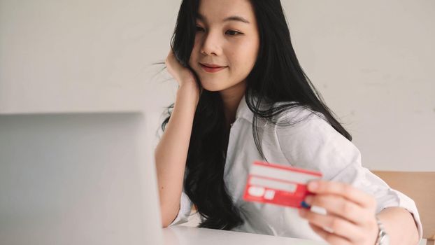 Shopping online with laptop computer and credit card on hand.