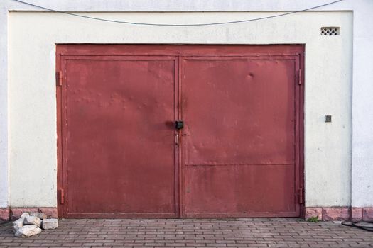 Old rusty garage doors closed.