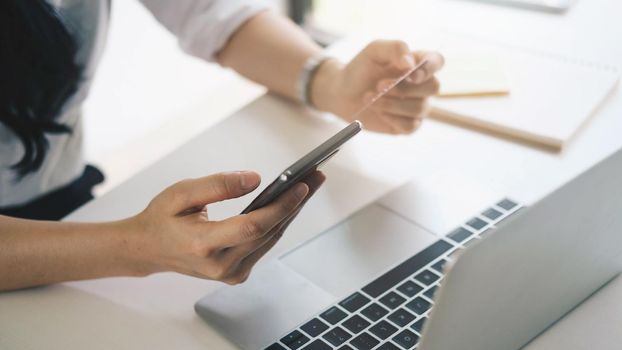 Close up hands holding credit card and using smart phone, Online shopping.