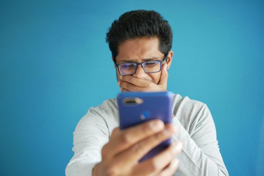 sad young man using smart phone indoor .