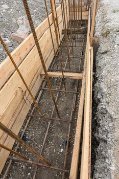 Reinforcement of the strip foundation, lower layer of reinforcement, unfinished formwork a