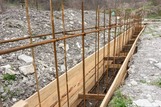 Reinforcement of the strip foundation with metal reinforcement, the top row of reinforcement is in focus a