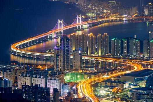 Busan cityscape with skyscrapers and Gwangan Bridge illuminated at night. Busan. South Korea