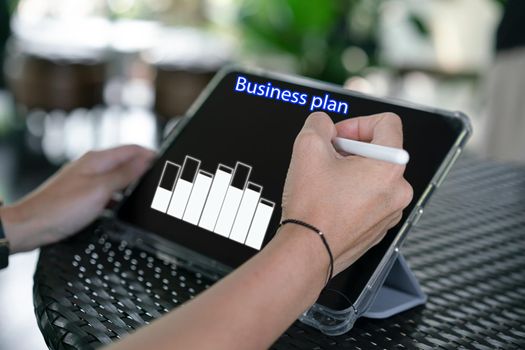 Hand use Tablet for online business plan
