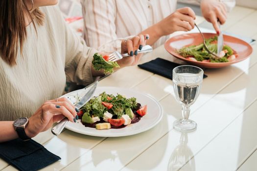 Close Up of Unrecognisable Women Having Lunch Meeting, Eating Salad in Restaurant