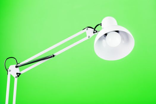 White table office lamp on green background with space for text and idea concept