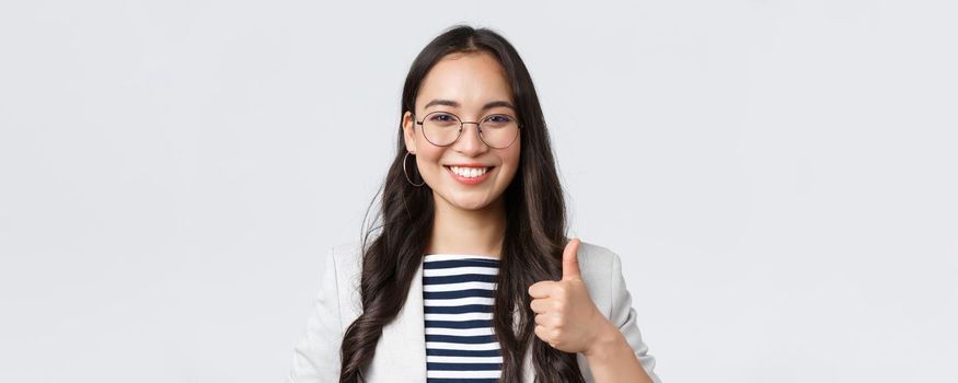 Business, finance and employment, female successful entrepreneurs concept. Confident smiling businesswoman provide best service, assure its good deal, thumbs-up in approval.