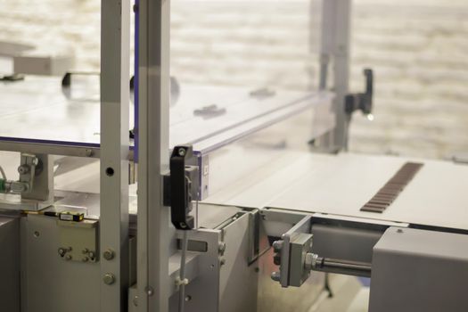 Line for the production of chocolate in an industrial factory. Automatic process in the production line of sweets. Images from the chocolate factory during production. Conveyor belt with sweets