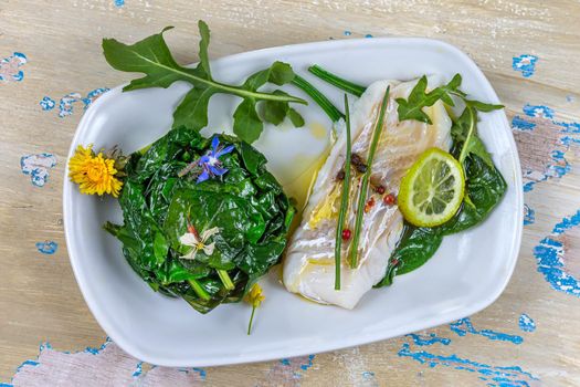 Cod back with drizzle of olive oil accompanied by spinach