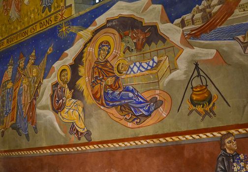 LE MANS, FRANCE - SEPTEMBER 17, 2017: Church St-Lazare with painted frescoes Christmas creche with Joseph Mary and small Jesus inside of artist Nikolay Greshniy