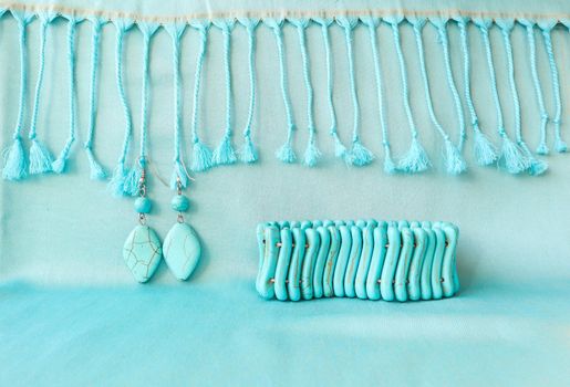 Turquoise bracelet and earrings from natural stone on fringed scarf