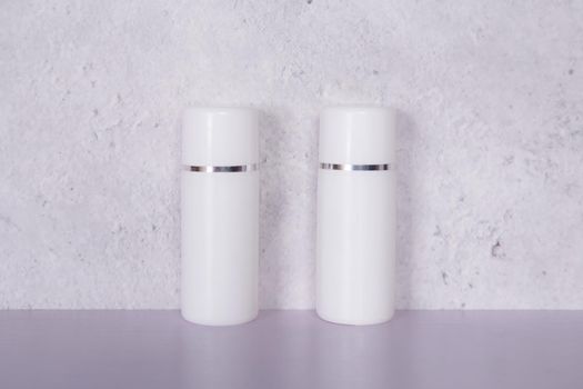 Mockup cosmetic bottle with cream or lotion on desk, mock up package for advertising, skincare or cosmetology, skin care and treatment with product.