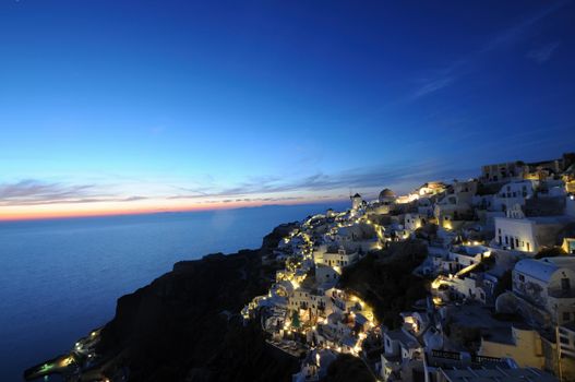 Scenic view of traditional cycladic Santorini houses in Oia village, full moon