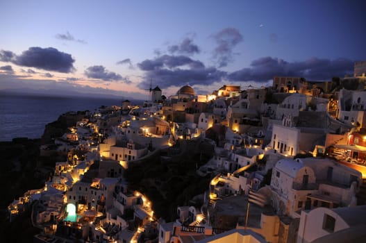 Astonishing evening view of Santorini island. Magnificent summer sunset on famous Greek resort Oia, Greece, Europe. Fantastic seascape of Mediterranena sea.