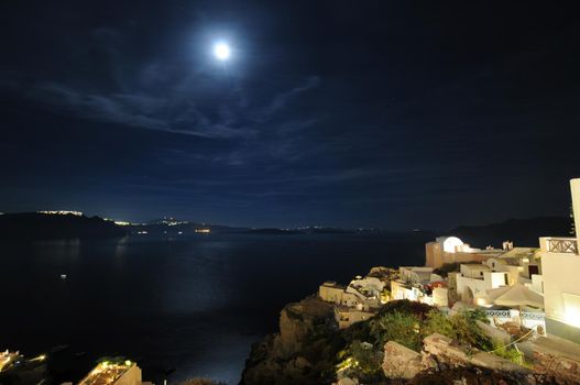 Scenic view of traditional cycladic Santorini houses in Oia village, full moon