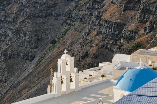 Greek Orthodox Church in Thira on Santorini Island with Line of Cruise Ships on Background