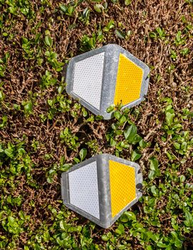 Close up of reflector on green fence