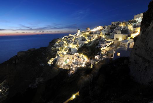 Scenic view of traditional cycladic Santorini houses in Oia village, full moon