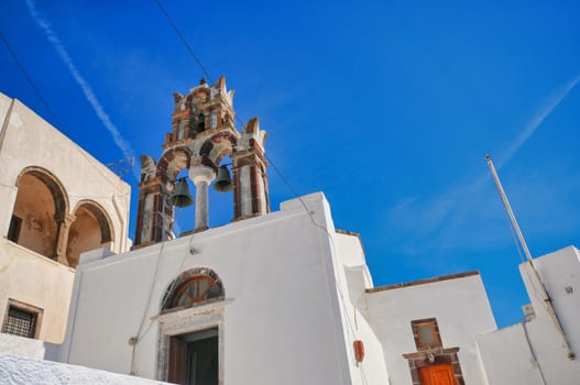 Pyrgos, Santorini, Greece. Famous attraction of white village with cobbled streets, Greek Cyclades Islands, Aegean Sea couple on vacation Santorini Greece Europe