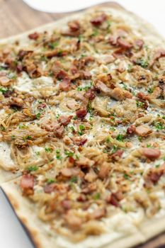 Flammkuchen tarte flambee traditional german alsace specialty pizza with onion and bacon