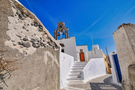 Pyrgos, Santorini, Greece. Famous attraction of white village with cobbled streets, Greek Cyclades Islands, Aegean Sea couple on vacation Santorini Greece Europe