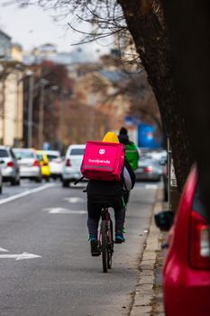 A Food Panda delivery courier on a bike  in Bucharest, Romania, 2022