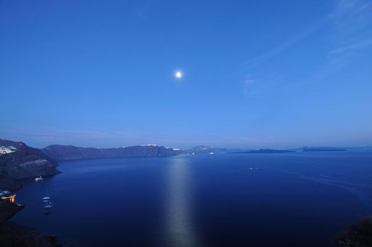 Sunset night view of traditional Greek village Oia on Santorini island in Greece. Santorini is iconic travel destination in Greece, famous of its sunsets and traditional white architecture