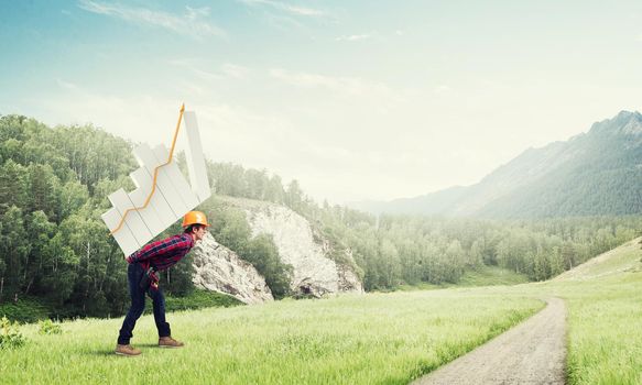 Young man builder carrying growing graph on his back