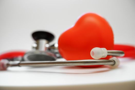 Stethoscope and red heart on white background, heart health, health insurance concept.