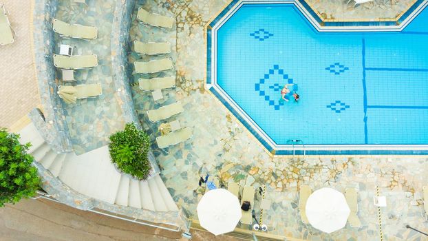 mother and daughter playing in a swimming pool.