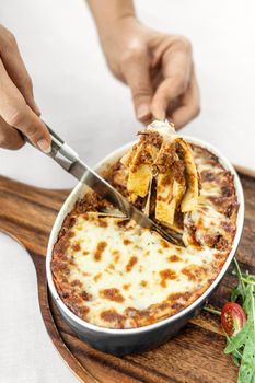 fresh beef lasagna in traditional oven dish on table in rome italy restaurant