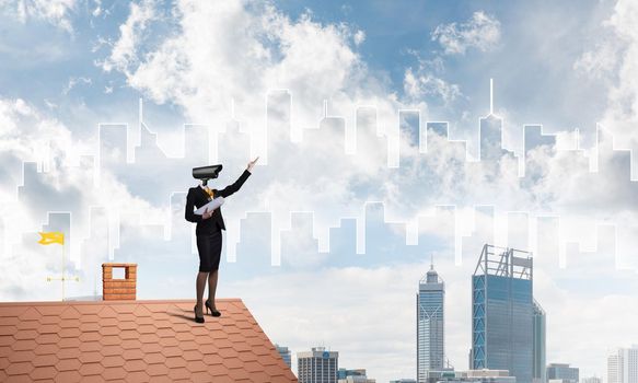 Faceless businesswoman with camera zoom instead of head standing on house roof