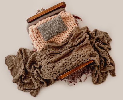 Newborn studio decoration tiny bed with brown knitted pillows and blanket for infant photoshoot. Craft furniture for child kid baby photos