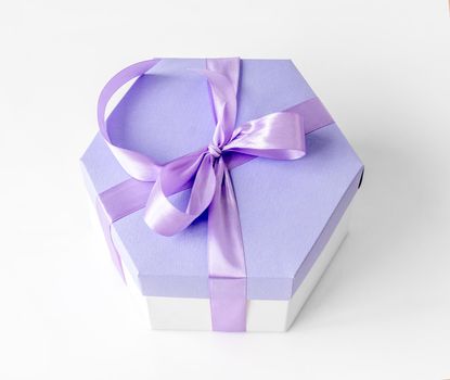 Beautiful gift box with lavander ribbon for celebration. Romantic present package from above view