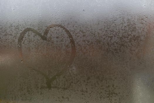 Heart on the Glass. heart on a foggy window.