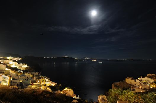 Scenic view of traditional cycladic Santorini houses in Oia village, full moon