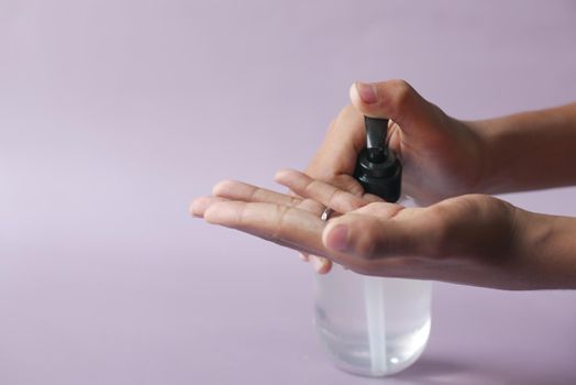 close up of young man hand using sanitizer gel for preventing virus.