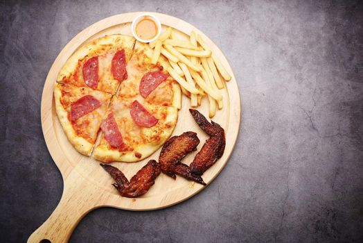 Slice of cheese pizza on a plate on wooden table