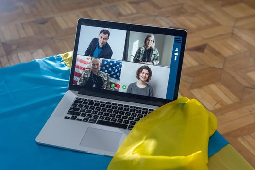 laptop with video conference near the flag of ukraine.