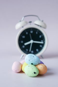 easter concept with egg and a clock on table ,