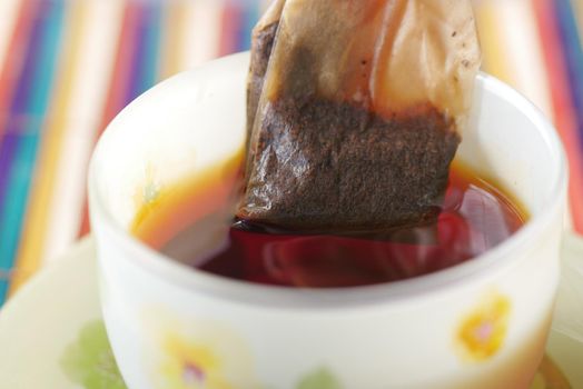 green tea and tea bag on table, close up