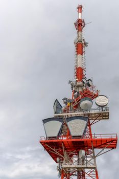 A part of communication tower with control devices and antennas, transmitters and repeaters for mobile communications and the Internet. Vertical view
