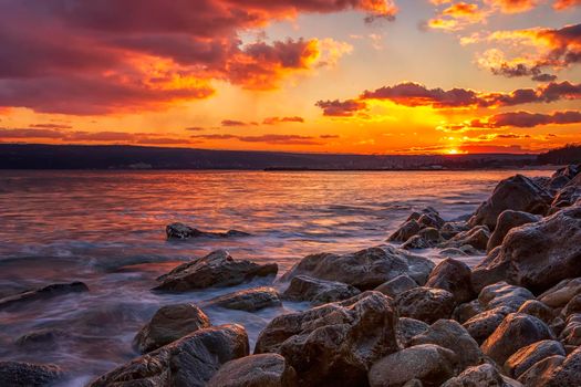 Sunning long exposure sunset over the sea with a rocky beach