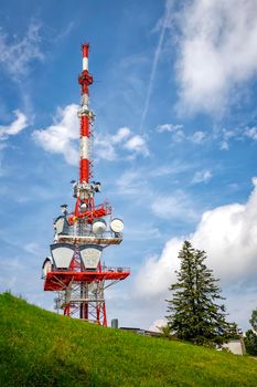 A part of communication tower with control devices and antennas, transmitters and repeaters for mobile communications and the Internet. Vertical view