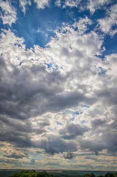 The vast blue cloudy sky. Vertical view